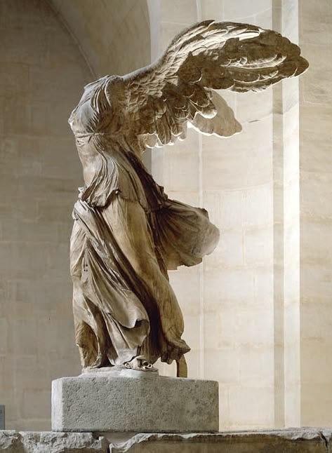 This may contain: an angel statue is shown in front of a stone wall with columns and light coming through it This may contain: an angel statue is shown in front of a stone wall with columns and light coming through it