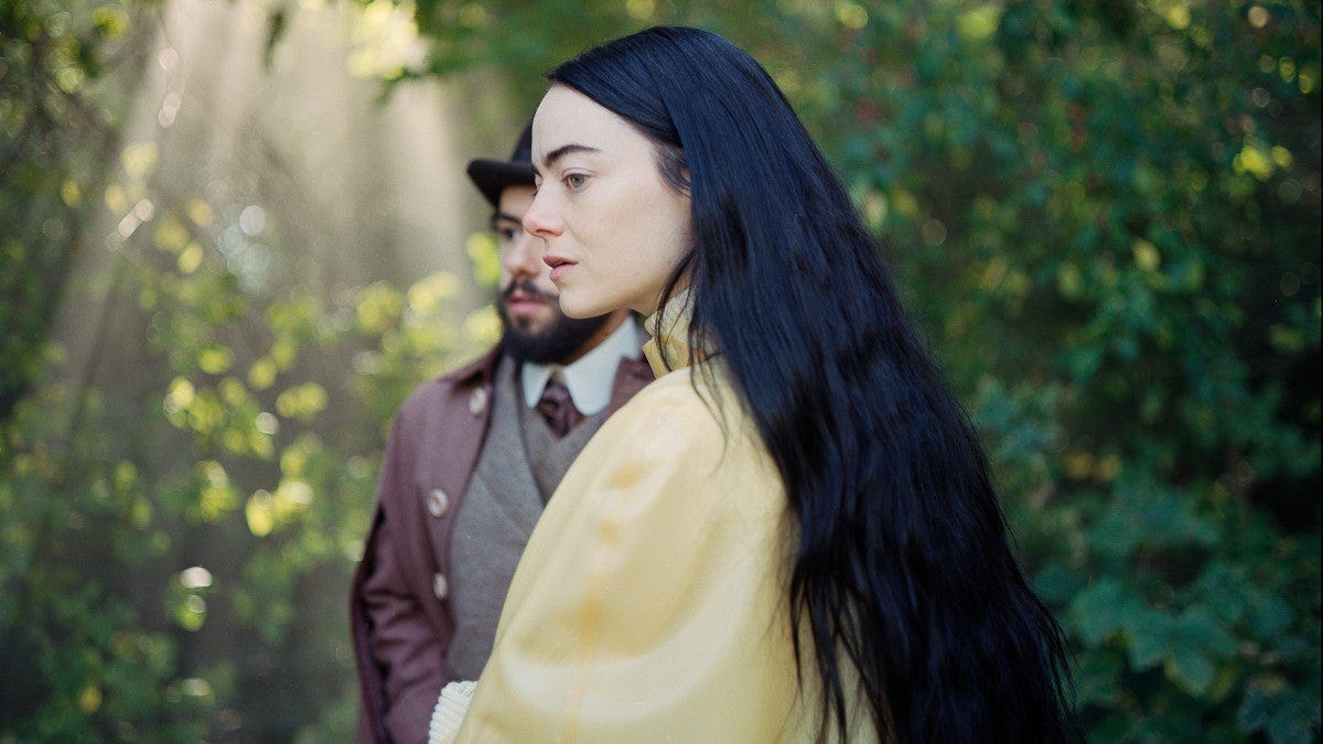 Emma Stone with long black hair, slightly obscuring Ramy Youssef, in "Poor Things" (2023)