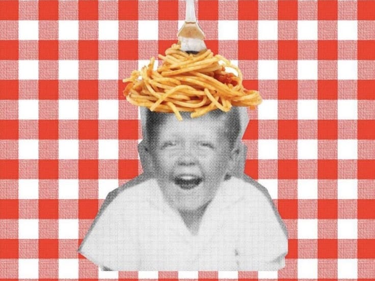 This may contain: a child with spaghetti on his head and fork sticking out of it's mouth