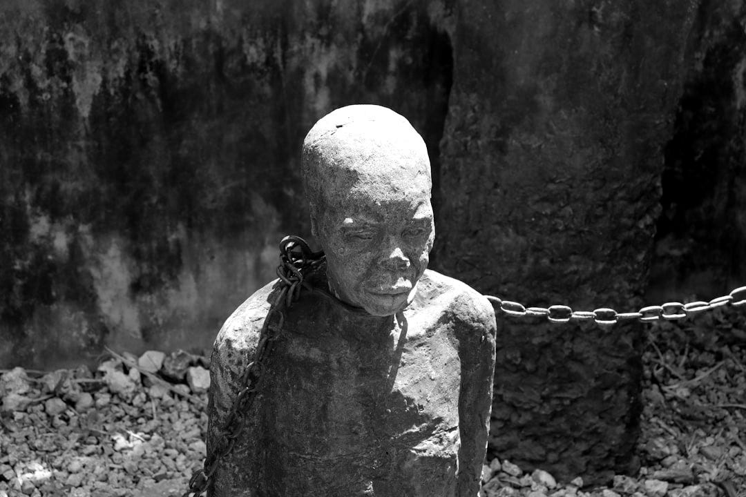 A statue of a person chained to a chain A statue of a person chained to a chain