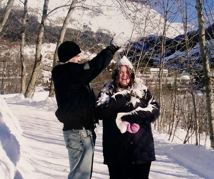 A man and woman in the snow + two teenagers