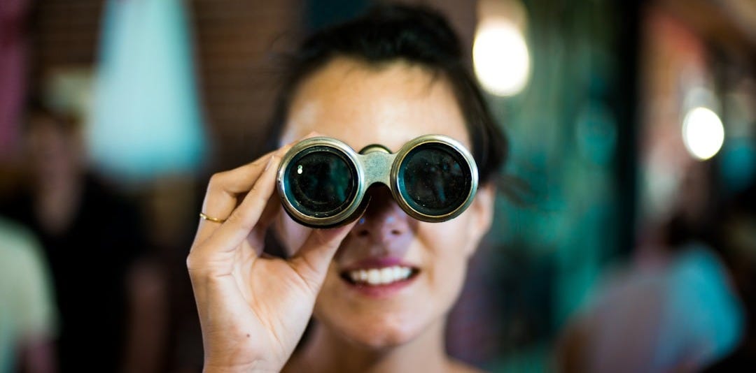 woman using gray binoculars
