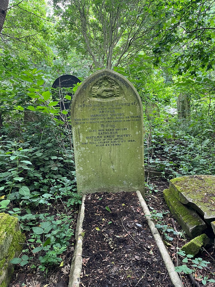 Six headstones with inscriptions of handshakes in a woodland cemetery