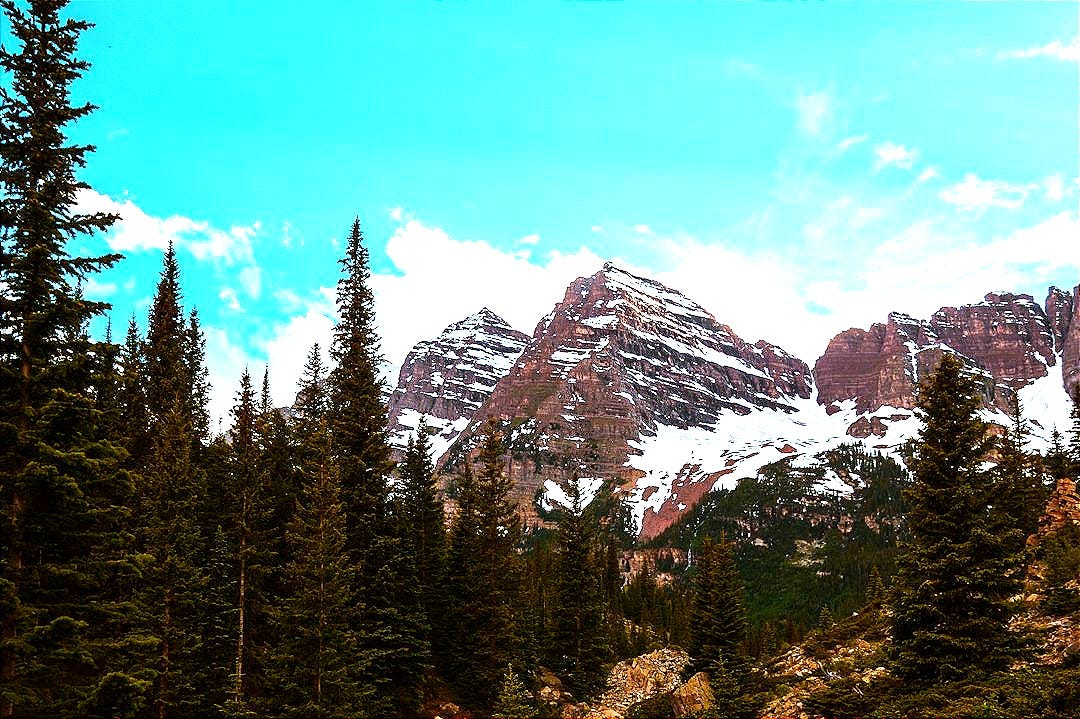 a trail leading to a mountain with snow on it