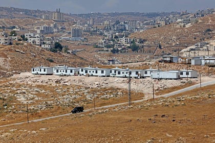 An Israel Police car driving past a newly established Israeli outpost in the Palestinian town of Beit Sahour, near Bethlehem, in the West Bank on Friday.