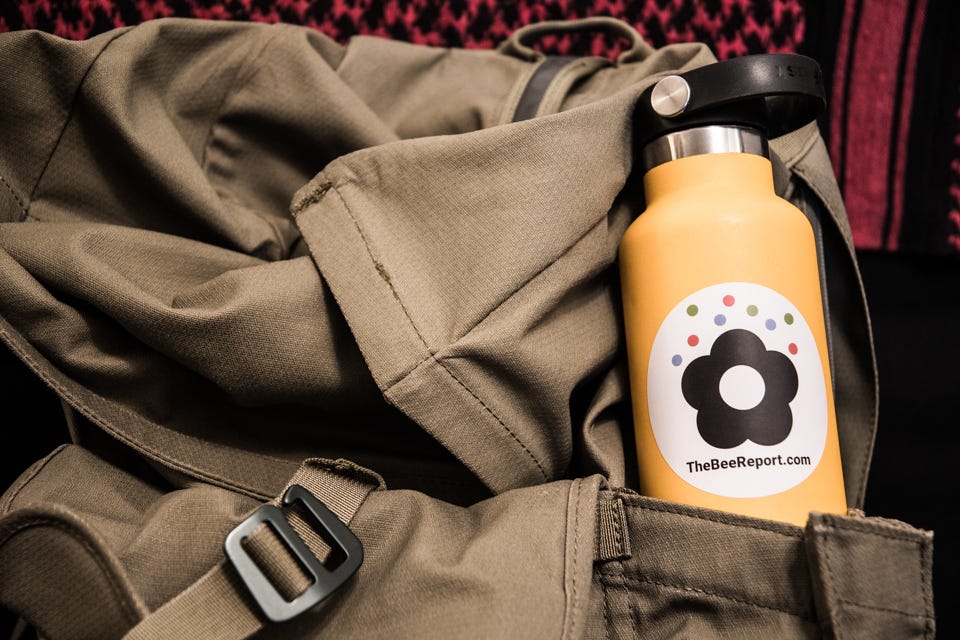 Image of Bee Report sticker on water bottle in backpack. Image of Bee Report sticker on water bottle in backpack.