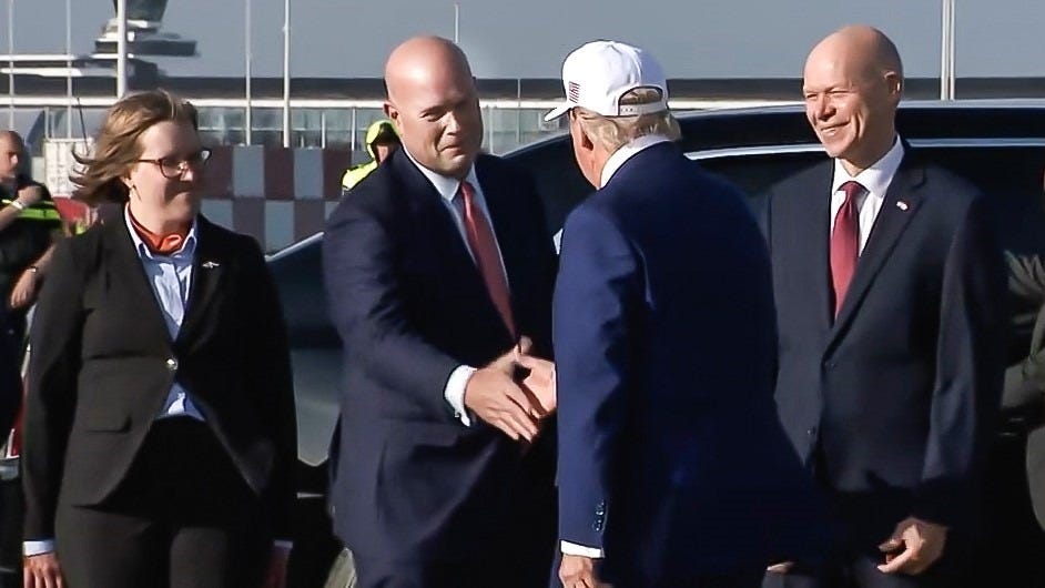 U.S. Ambassador to NATO shakes President Trump's hand.
