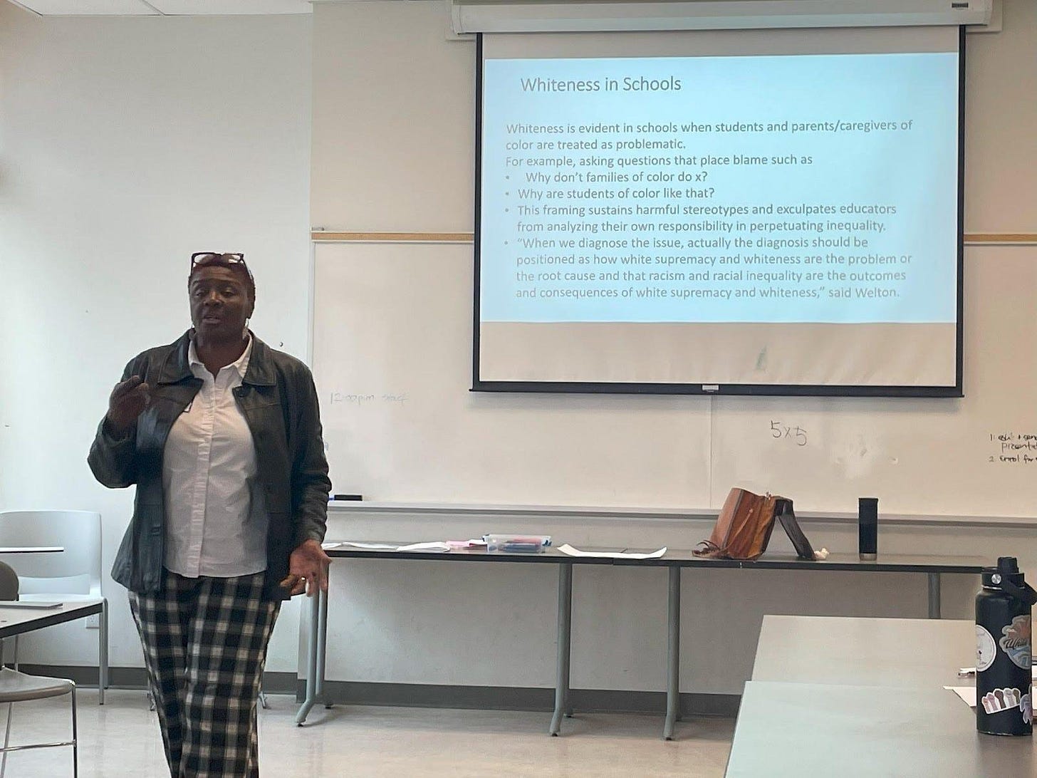 A person standing in front of a projector screen

AI-generated content may be incorrect.