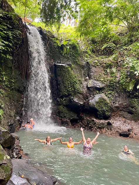 Women writing, participating in a Balinese blessing, standing by rice fields and swimming in a waterfall
