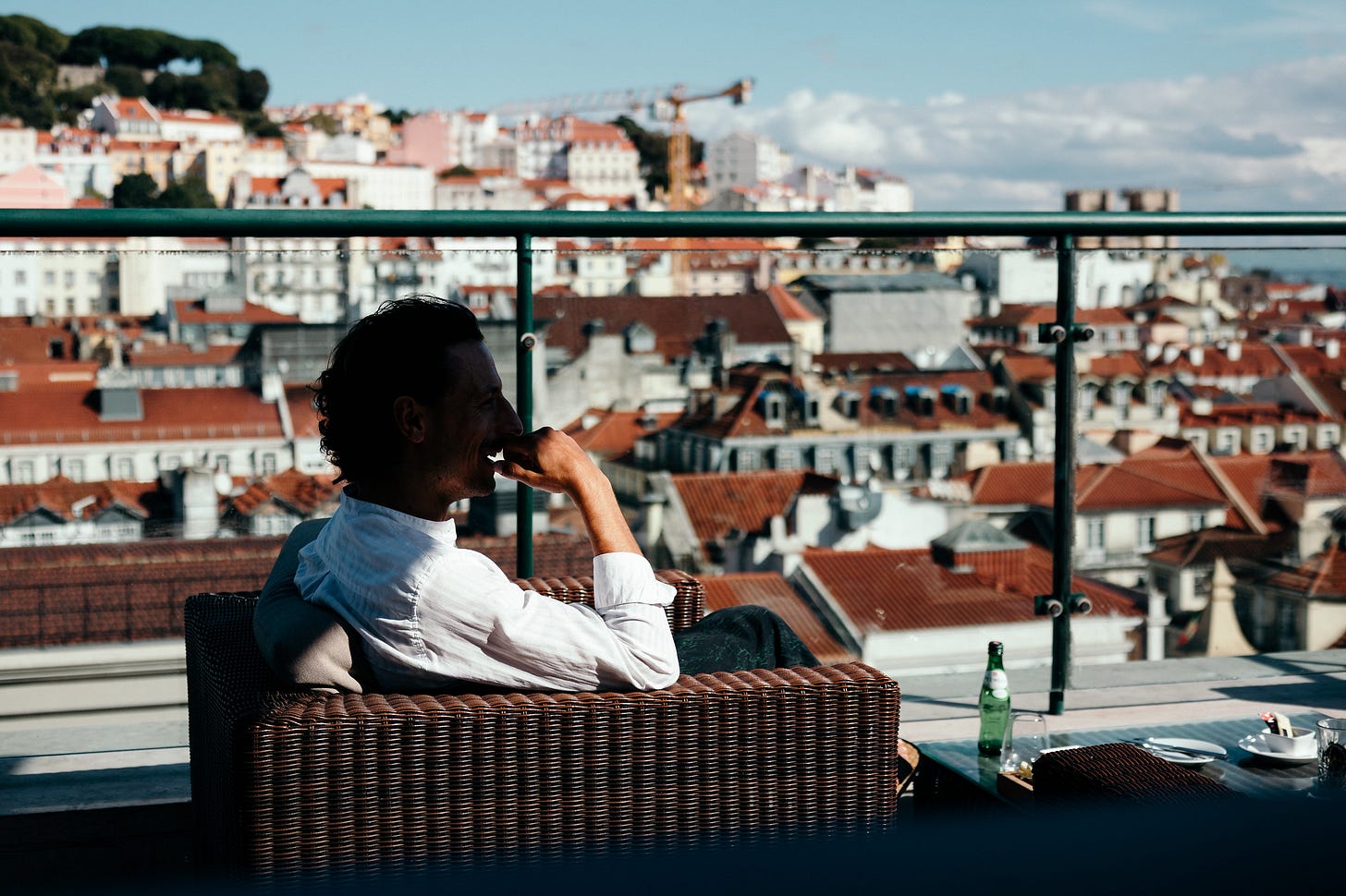 Frenchman sitting at a rooftop bar in Lisbon, Portugal