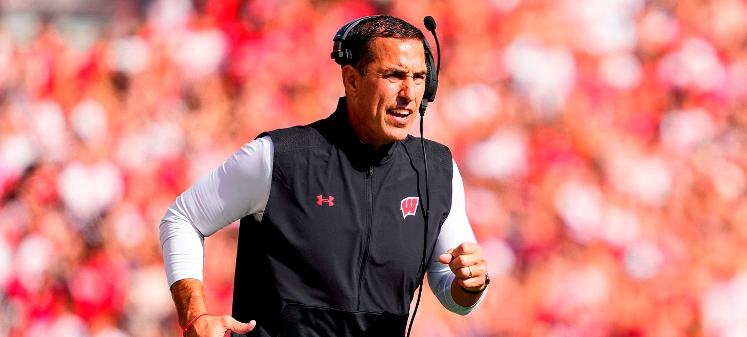 Wisconsin Badgers head football coach Luke Fickell runs onto the field 