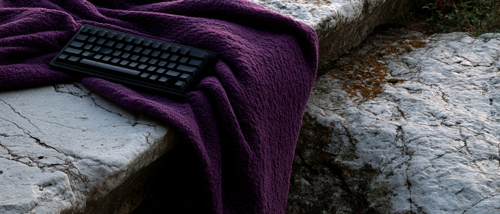 A length of deep Tyrian purple wool cloth draped loosely across a worn marble ledge