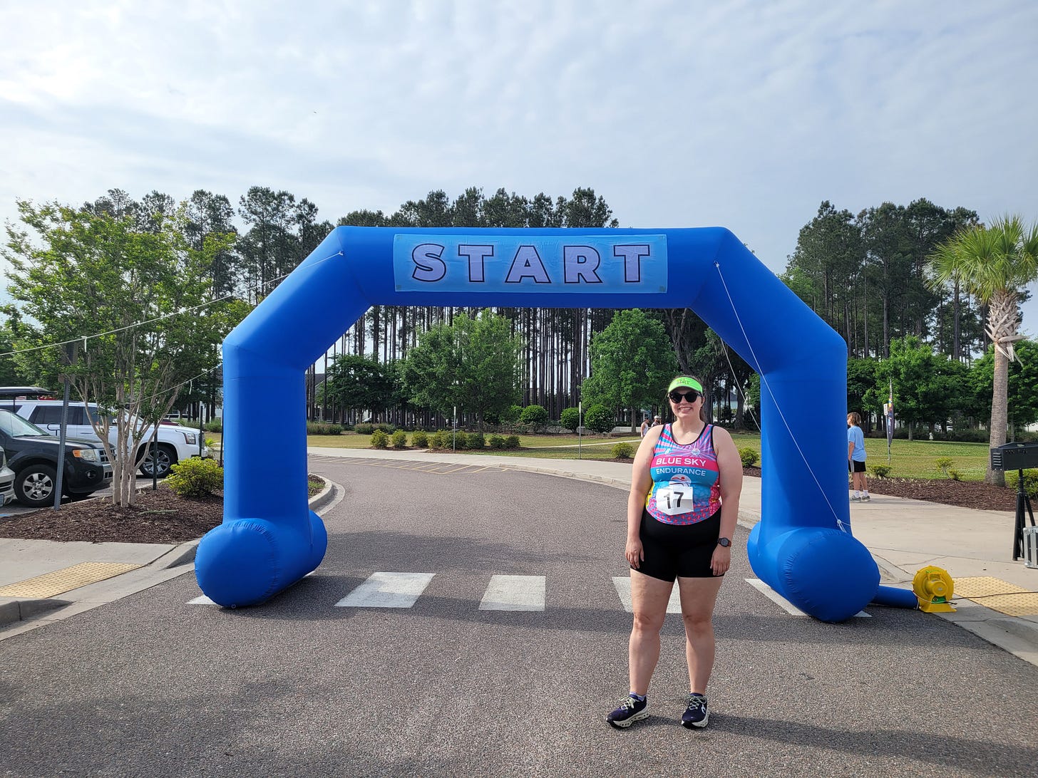 Sydney stands in front of the start arch at a 5K in Summerville, SC, where she PRed in the 5K distance.