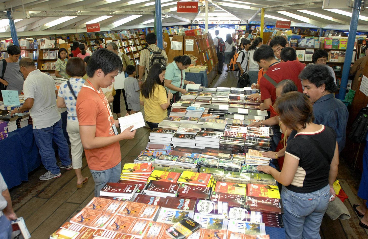 Filipino visitors buy books onboard MV D