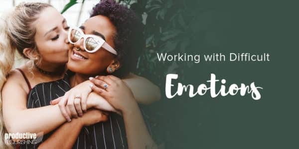 A femme couple hug each other, one partner is behind the other, kissing the cheek of her partner. Text Overlay: Working With Difficult Emotions. A femme couple hug each other, one partner is behind the other, kissing the cheek of her partner. Text Overlay: Working With Difficult Emotions.