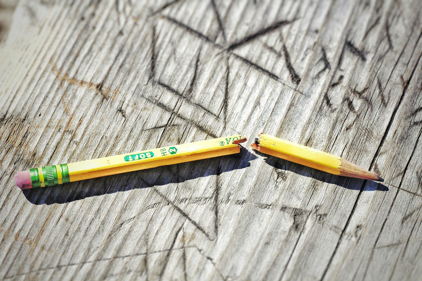 broken pencil on wooden table