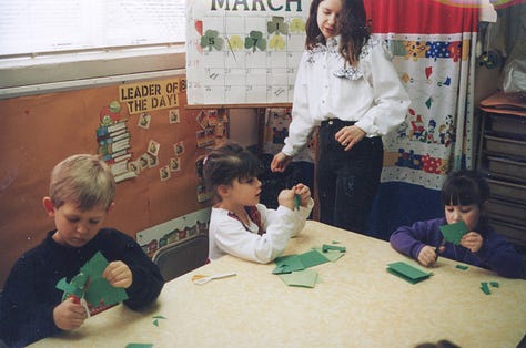 Children making paper shamrocks for St. Pat's Day