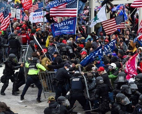 large group holding trump and american flags pushes at barricade while police officers stand on opposite side large group holding trump and american flags pushes at barricade while police officers stand on opposite side