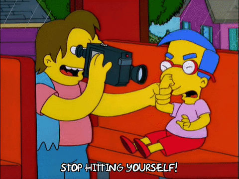 Simpsons clip: bully using nerd's hand to hit him, while saying "stop hitting yourself!"