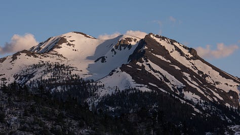 Snow capped mountain peaks and alpine lakes