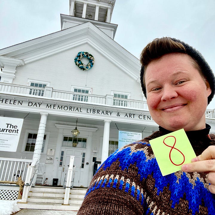 On the left, Hannah is standing in front of the Stowe Free Library in a hand-knit sweater and hat holding a sticky note with the number eight on it. Sadly, Hen Solo did not exist yet, so there is no Hen Solo. On the right, there is a map of the state of Vermont with the town of Stowe highlighted in red.