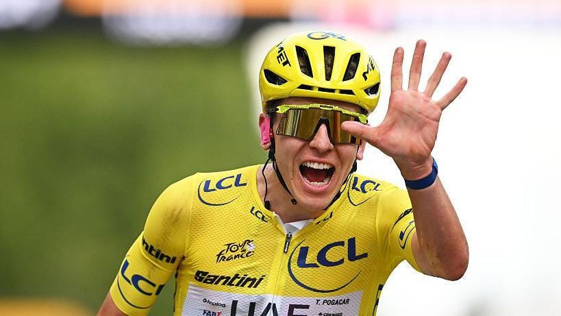 Tadej Pogacar celebrates winning a fifth Tour de France by showing five fingers Tadej Pogacar celebrates winning a fifth Tour de France by showing five fingers