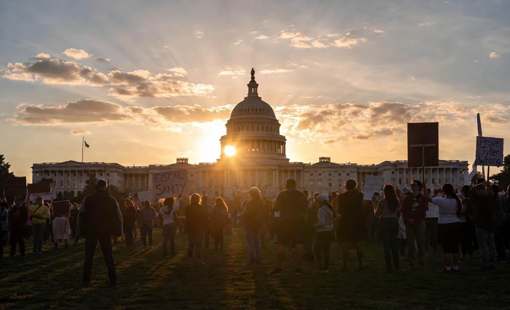 The image depicts a crowd of people gathered outside the U.S. Capitol building under a partly cloudy sky, possibly during a protest or public gathering.
AI-generated content may be incorrect. The image depicts a crowd of people gathered outside the U.S. Capitol building under a partly cloudy sky, possibly during a protest or public gathering.
AI-generated content may be incorrect.