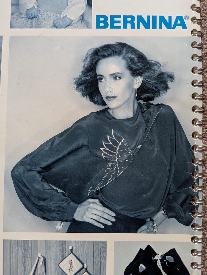 A photo on the left of a small (three inch?) bottle of oil, maybe 3/4 full. A photo on the right of a shiny white lady with her hair being blown back dramatically, wearing a very 1980s dolman-sleeve top with some sort of elaborate embroidery on it.