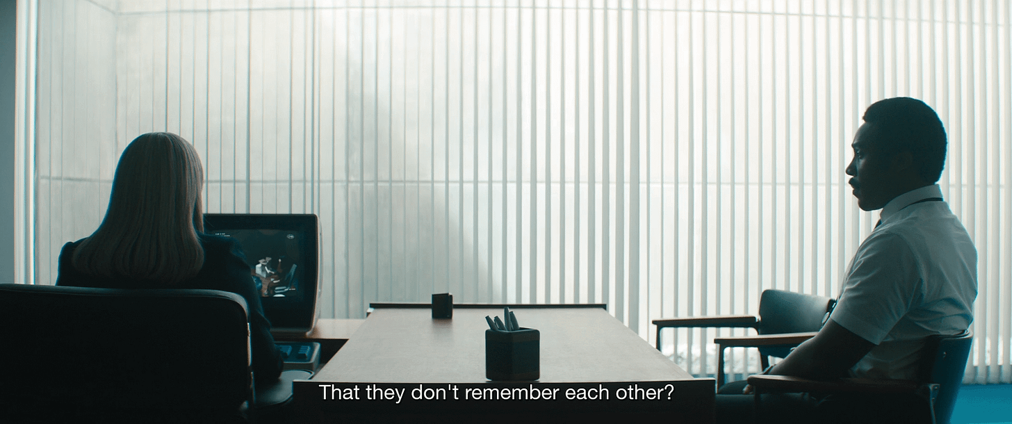 Harmony Cobel sitting at her desk with Milchick sitting closeby. The subtitles read "That they don't remember each other?"