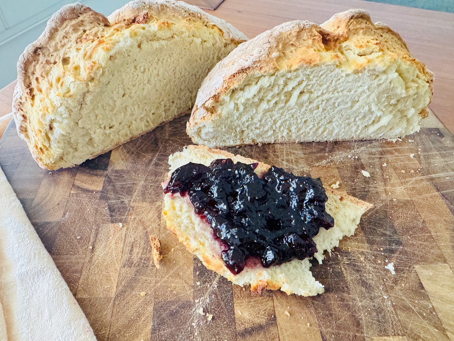 White Irish soda bread sliced in half showing a crisp golden crust on top and soft tender crumb inside White Irish soda bread sliced in half showing a crisp golden crust on top and soft tender crumb inside
