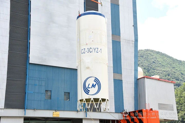 The Long March 3C/E's second-stage arriving at the launch pad and being lifted onto the rocket.