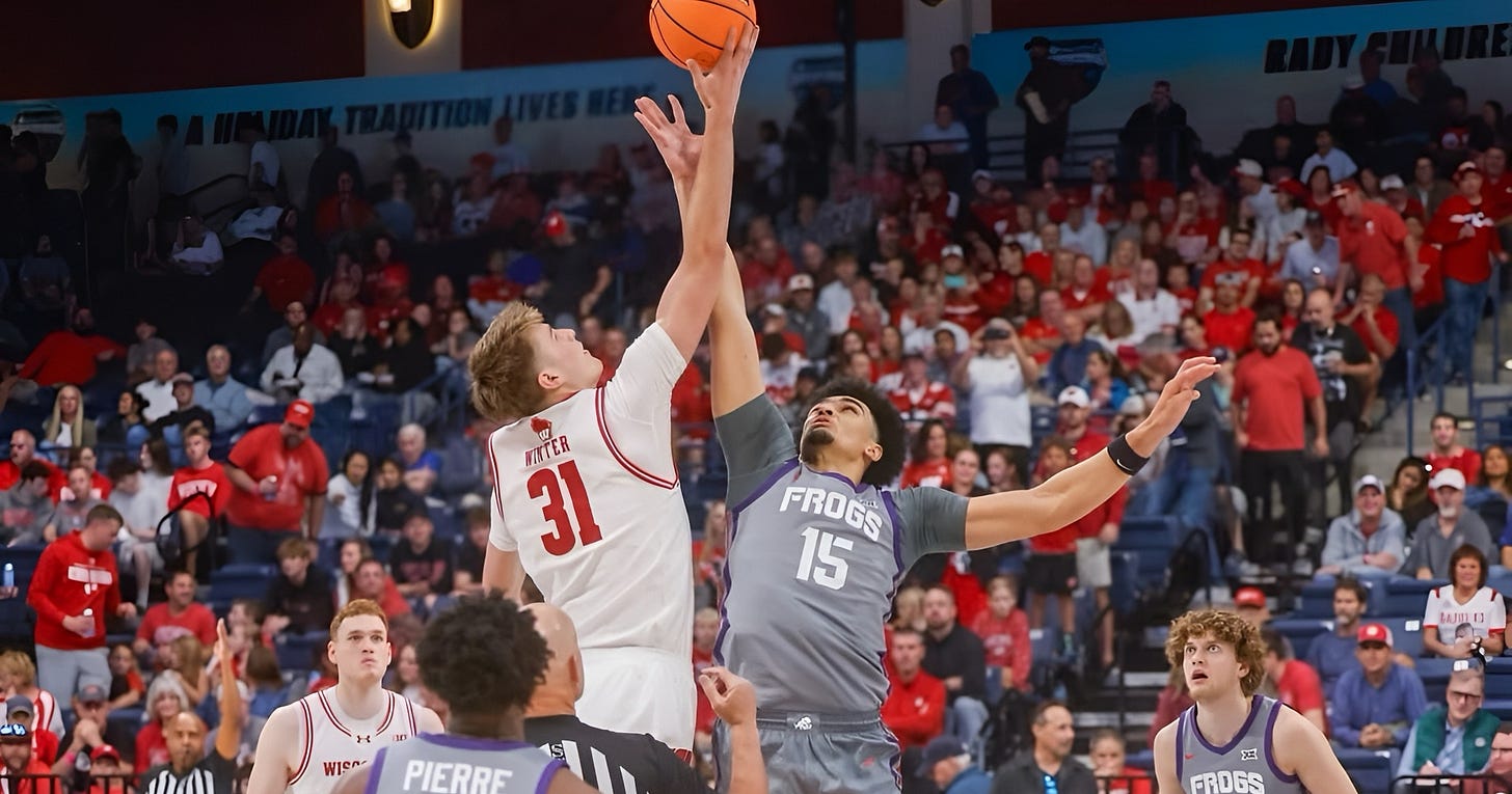 Wisconsin Badgers forward Nolan Winter rises up for the opening jump ball against TCU. Wisconsin Badgers forward Nolan Winter rises up for the opening jump ball against TCU.