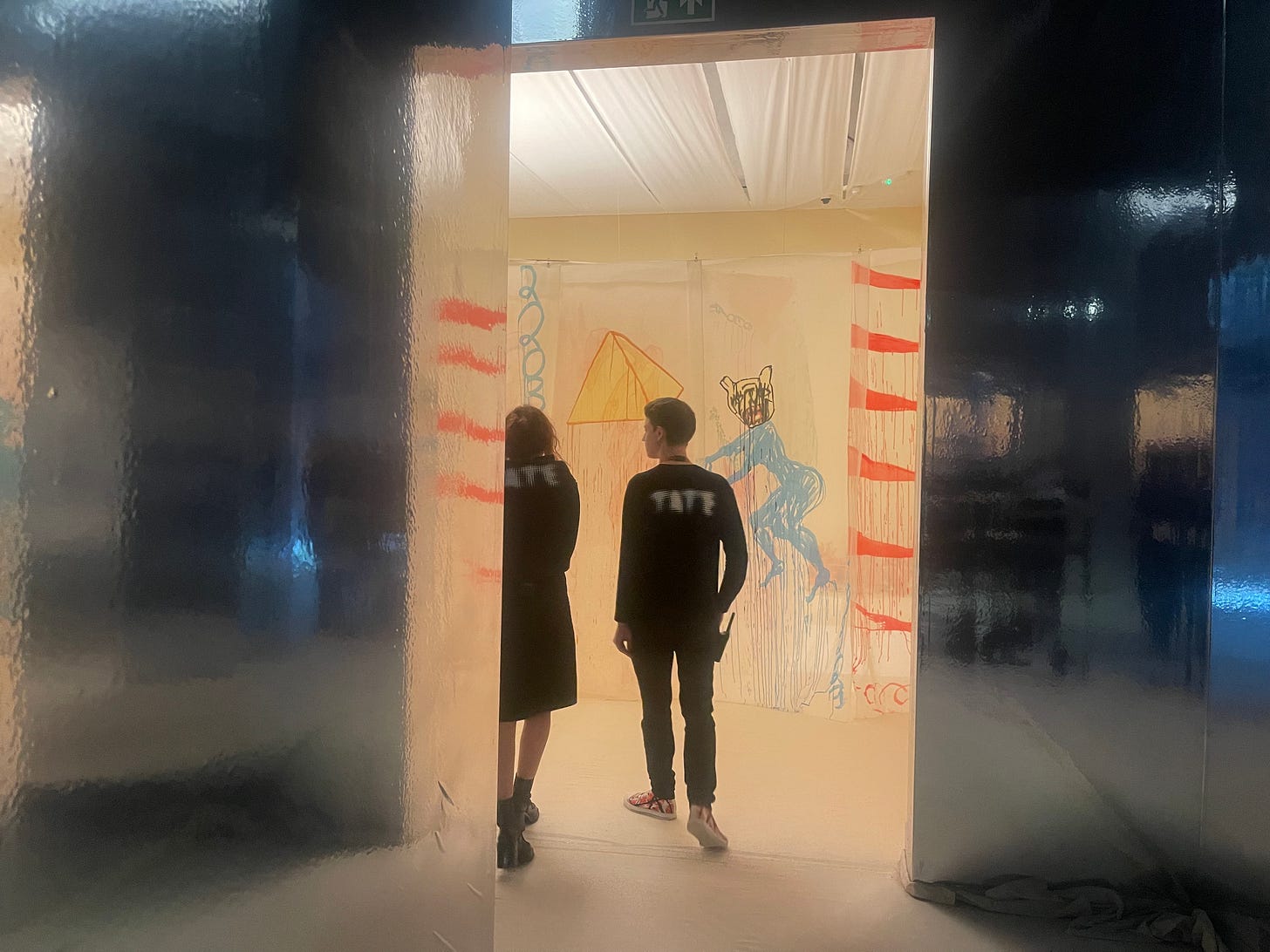 Images of installation by Delaine de Bas, Tate workers walking through golden pyramid, Know Thyself script, and temple of the sun with joined dancers