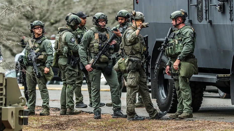 DeKalb, Ga., and Atlanta SWAT members are pictured leaving the Gresham Park command post in Atlanta on Wednesday, Jan. 18, 2023. 