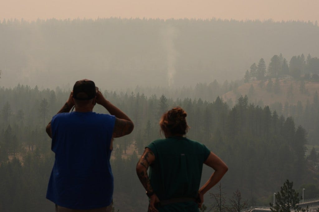 People view smoke rising from the Old Trails wildfire in the northwest part of Spokane, Wash., Monday, Aug. 3, 2026. People view smoke rising from the Old Trails wildfire in the northwest part of Spokane, Wash., Monday, Aug. 3, 2026.