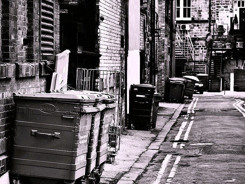 A side street with bins