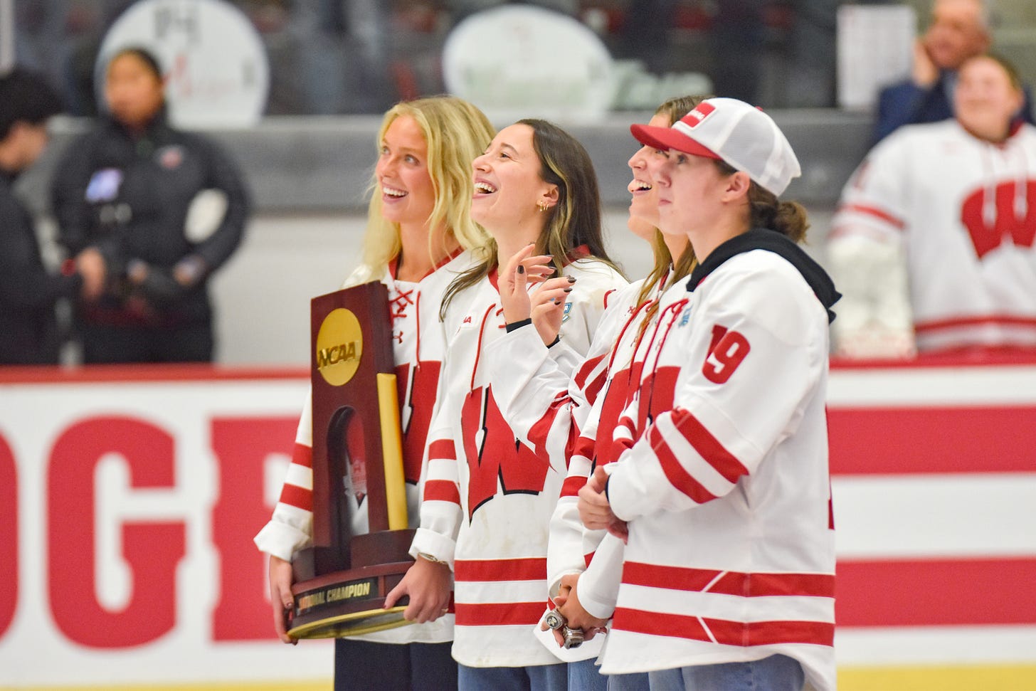 Wisconsin hockey alumnae smile and laugh