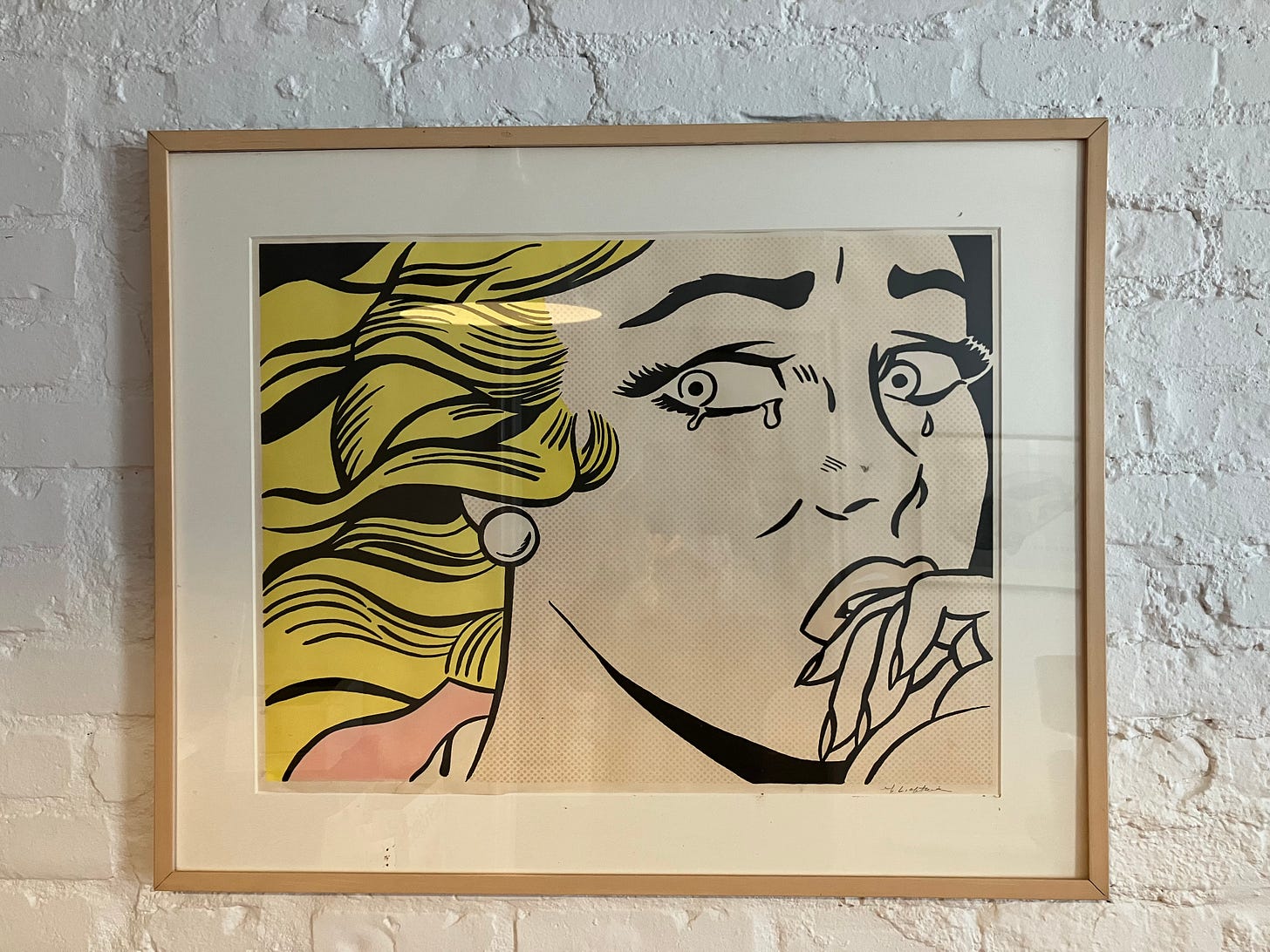 framed illustrated print of a blond woman with a hand to her mouth, crying