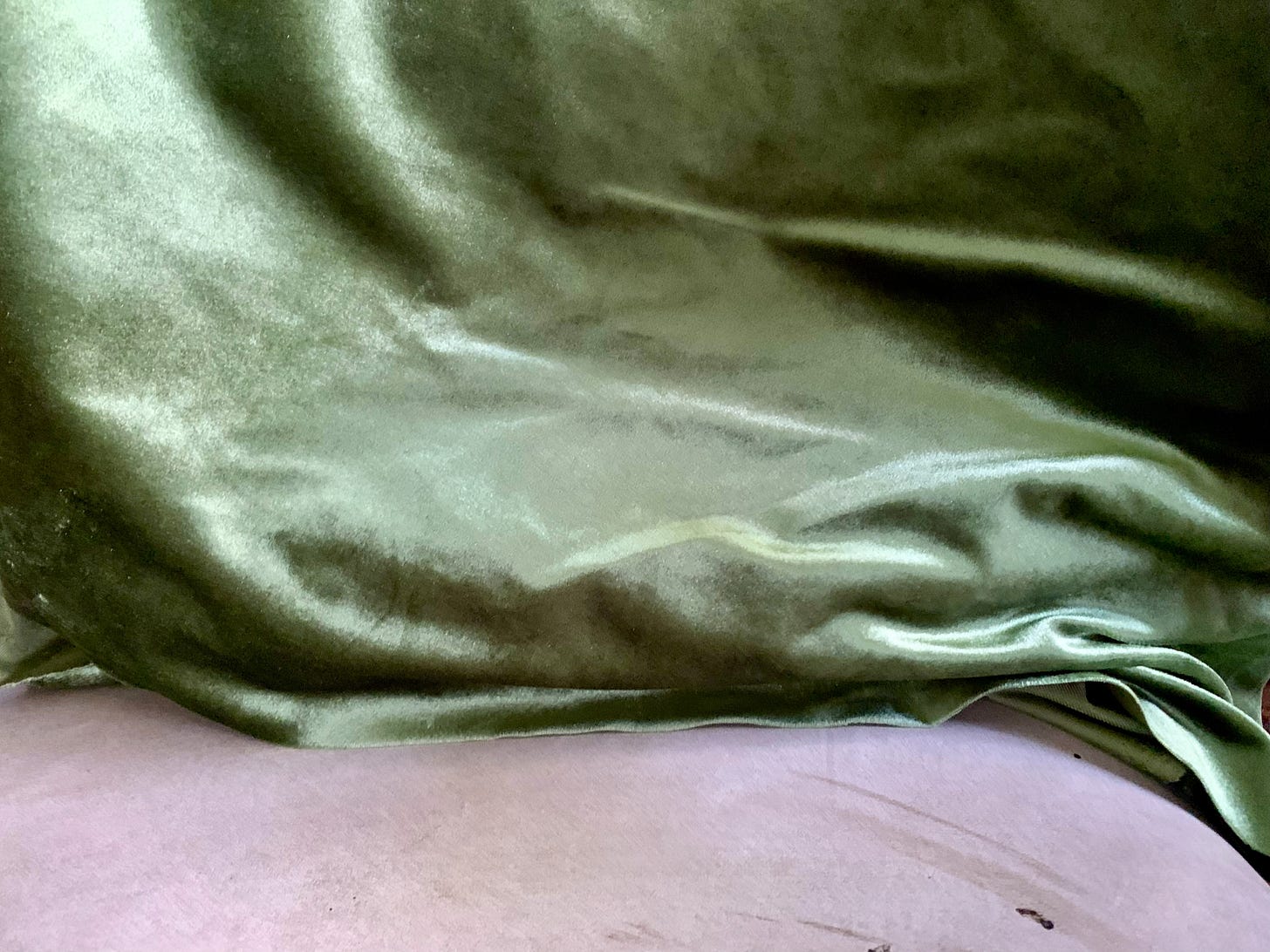 An image of green velvet cloth over a chair An image of green velvet cloth over a chair