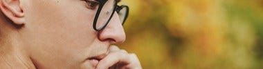 boy with glasses thinking