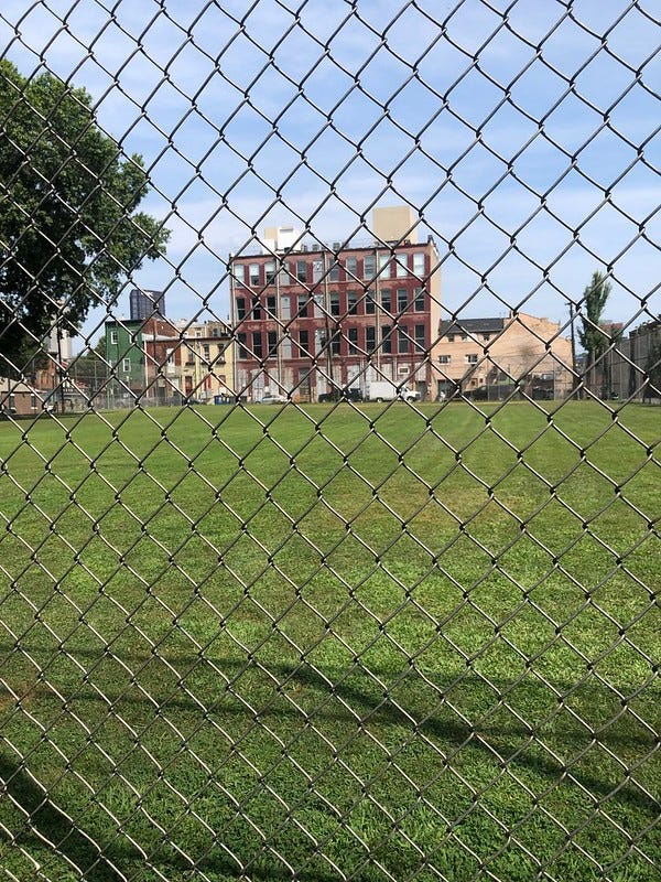 Armstrong Field with old building in the background.