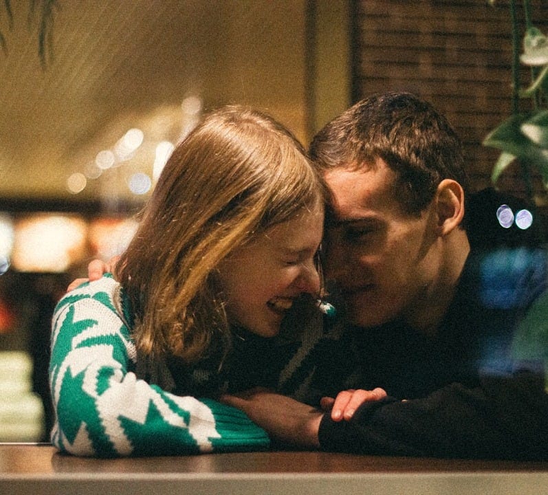 a man and a woman embracing each other