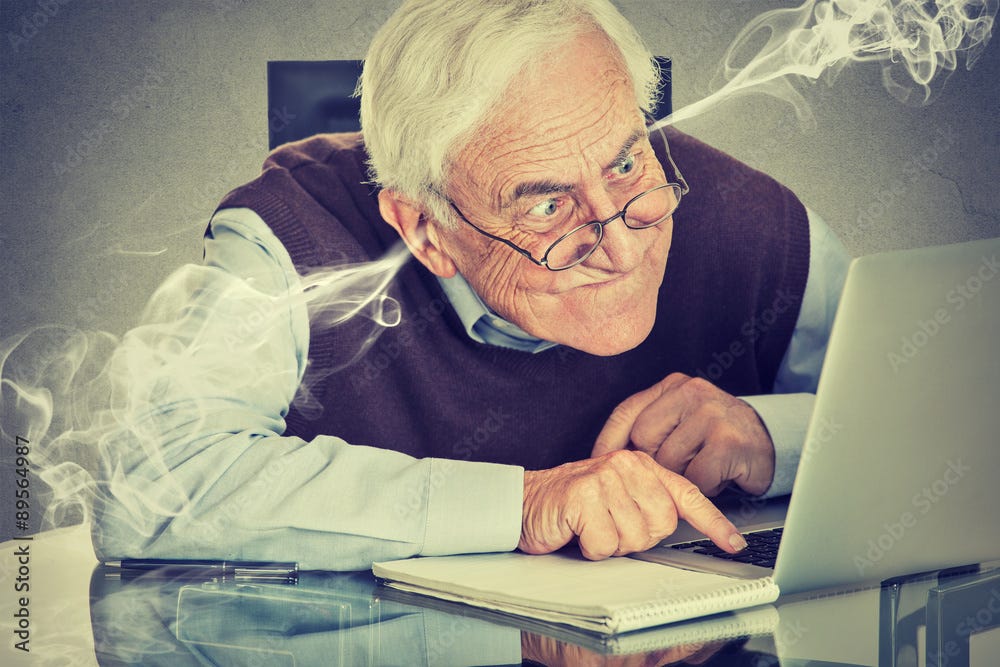 Frustrated elderly old man using laptop computer sitting at table Stock  Photo | Adobe Stock