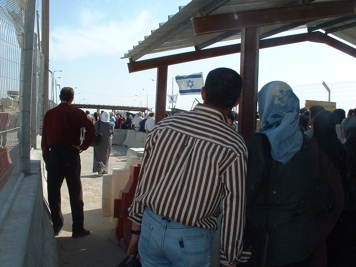 Left: A crowd of Palestinians — men and women, some in headscarves — queue under a corrugated metal canopy at Qalandia checkpoint. A chain-link fence runs along the left. Concrete barriers channel the line forward. An Israeli flag is visible in the middle distance. Additional waiting crowds stretch toward the checkpoint inspection point in the background. Right: A view toward the Qalandia checkpoint gate in December 2005. Rubble and debris fill the foreground. A security gate and white terminal building are visible in the background, with a billboard bearing a red rose and Arabic text reading "The Hope for All of Us." Several men walk along a concrete path to the left. Floodlights on tall poles frame the scene under a clear blue sky.