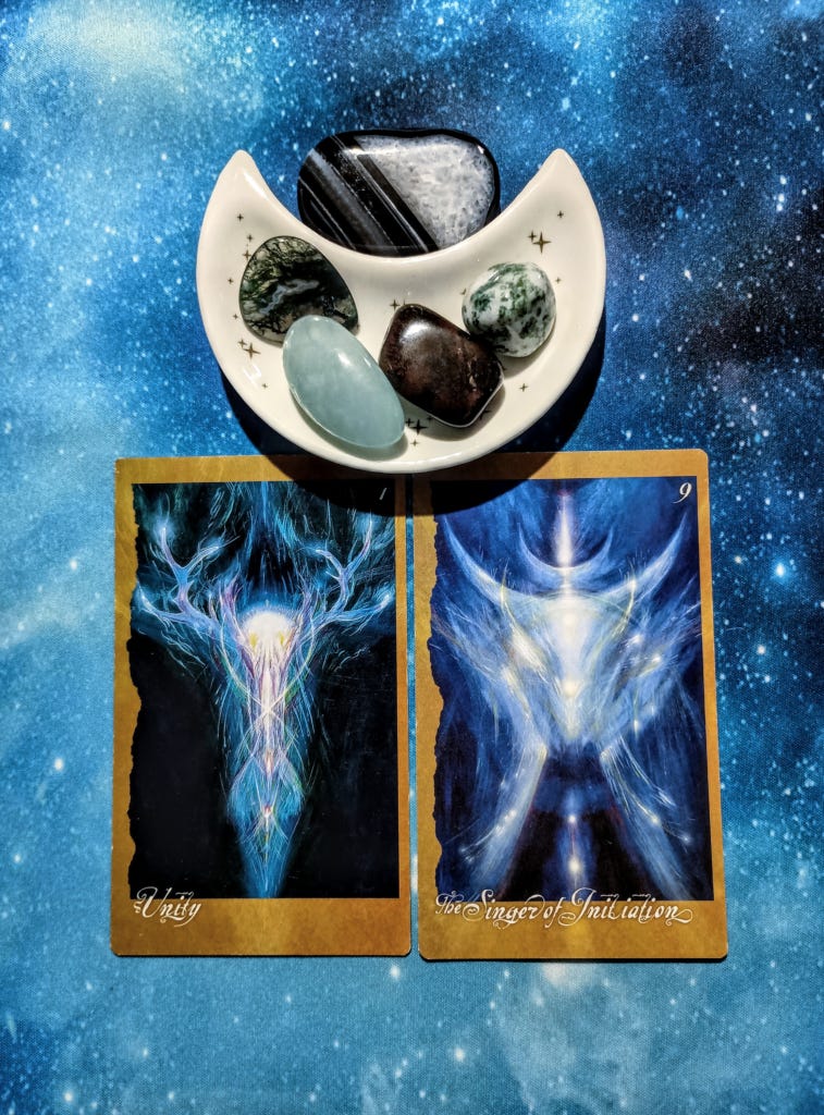 We Are All One: A Message From the Universe, 2 Faeries’ Oracle cards and crystals on a starry blue background We Are All One: A Message From the Universe, 2 Faeries’ Oracle cards and crystals on a starry blue background