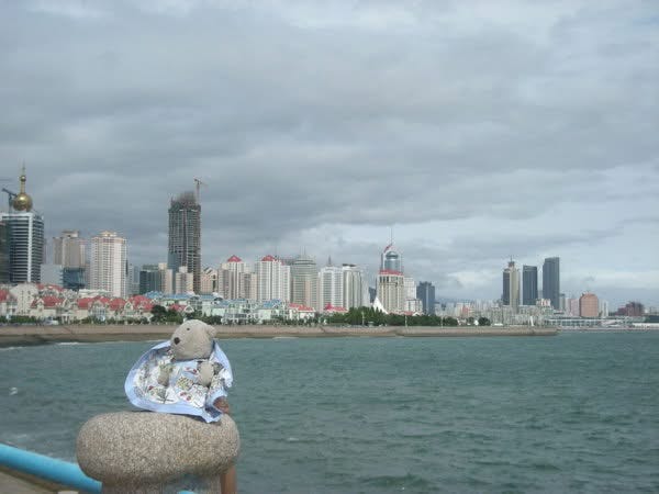 Nathaniel Bear teddy bear in front of waterfront