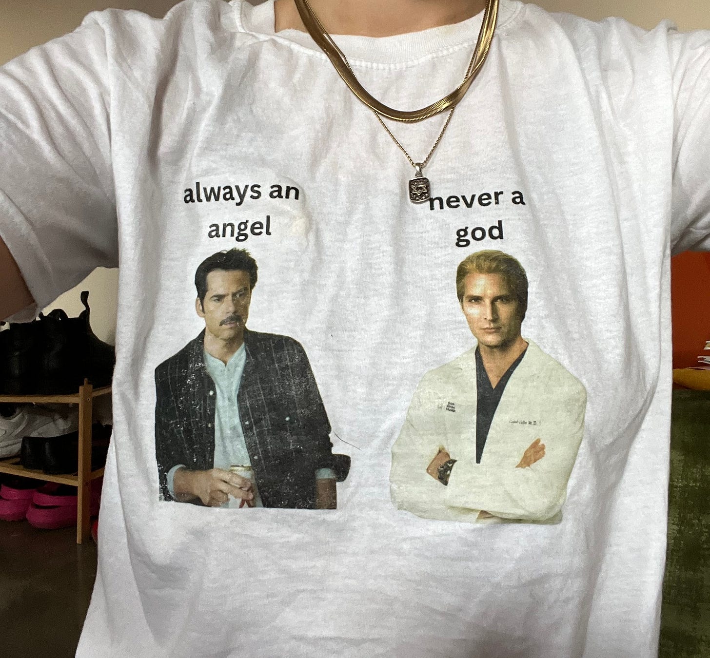 A shirt with images of Charlie and Carlisle from Twilight that says "always an angel / never a god."