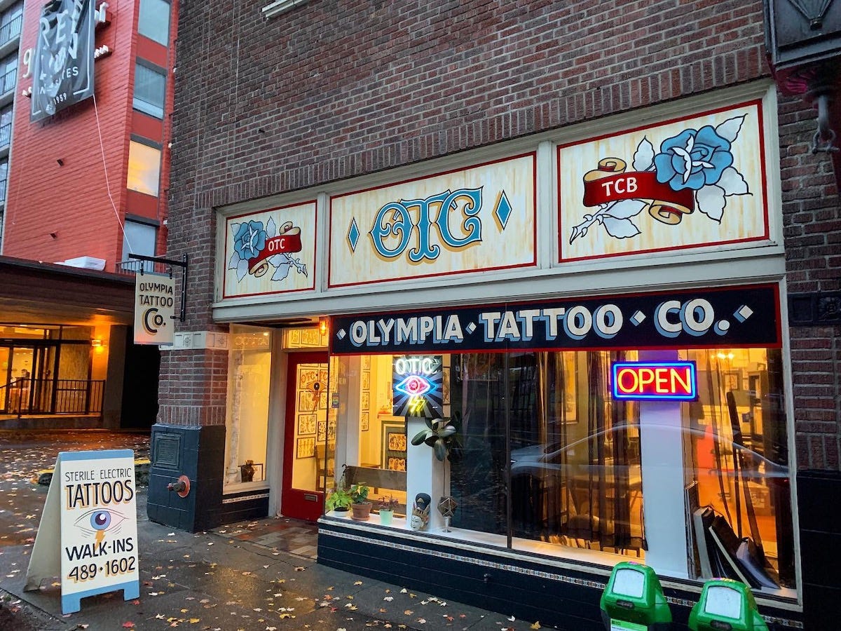 Ira Coyne's work on the storefront and sandwich board for Olympia Tattoo