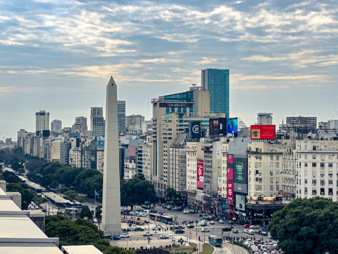 A view of a city with tall buildings and a obelisk A view of a city with tall buildings and a obelisk