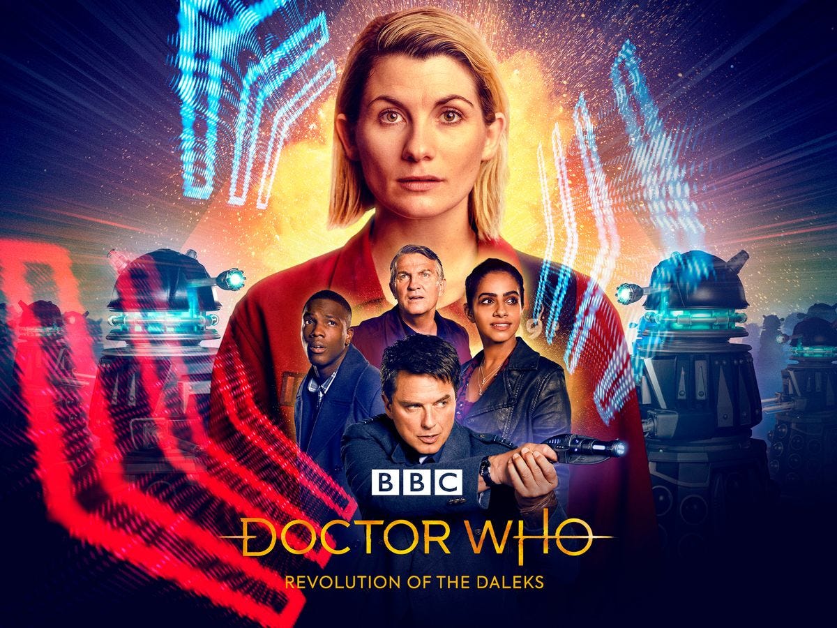 This image shows the BBC's official, colorful one-sheet poster for "Revolution of the Daleks." The Thirteenth Doctor (dressed in a prison jumpsuit) occupies the largest, center space, while her three companions are arrayed below her. Captain Jack Harkness (pointing his laser blaster to his left) occupies space below the companions. Several Daleks can be seen on both sides of these characters.